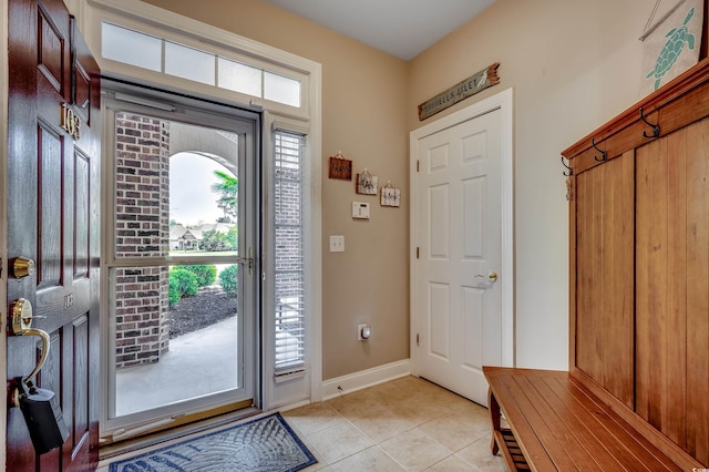 entryway featuring light tile patterned floors and baseboards