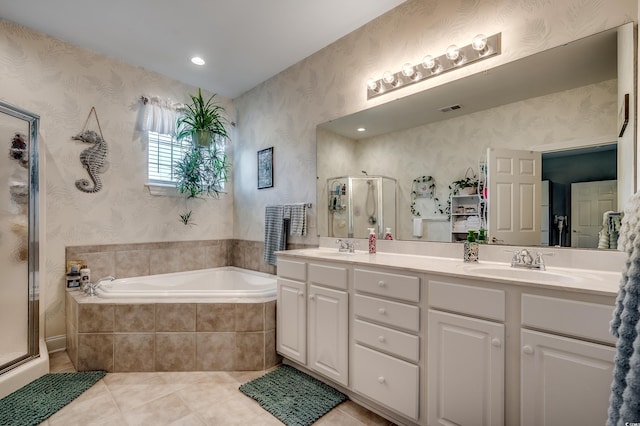 full bath with a bath, a sink, a shower stall, wallpapered walls, and tile patterned floors