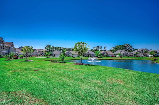 view of yard featuring a residential view and a water view