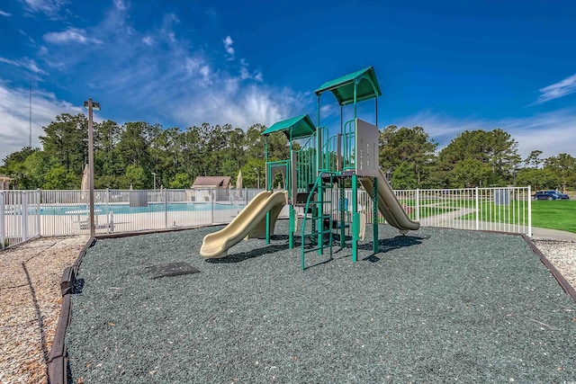 community play area featuring a community pool and fence