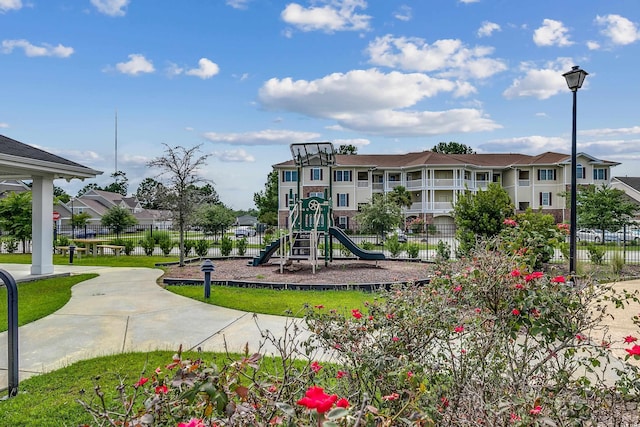 community jungle gym with fence and a residential view