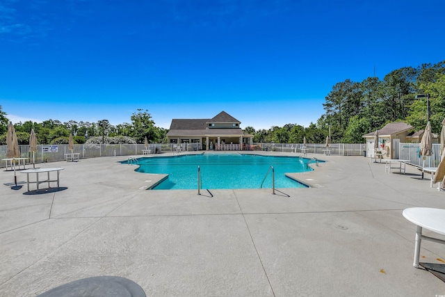 pool featuring fence and a patio