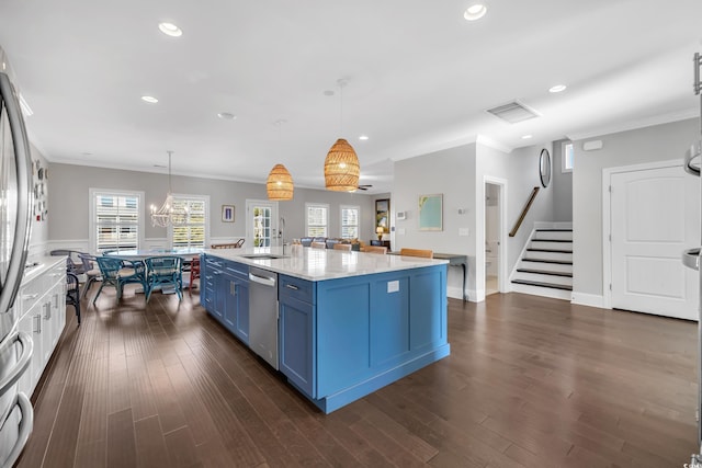 kitchen with blue cabinets, a sink, ornamental molding, stainless steel dishwasher, and dark wood finished floors