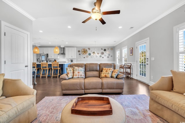 living room featuring ceiling fan, ornamental molding, dark wood-style flooring, and recessed lighting