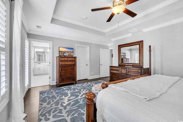 bedroom with dark wood-type flooring, a raised ceiling, and multiple windows