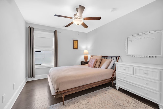 bedroom featuring dark wood-style flooring, ceiling fan, and baseboards