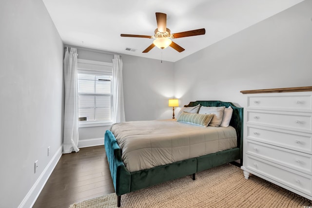 bedroom with light wood-style floors, a ceiling fan, and baseboards