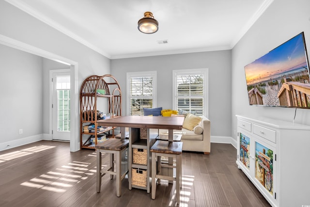 dining room with dark wood-style floors, crown molding, and a wealth of natural light