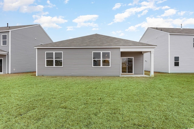 back of house featuring a lawn