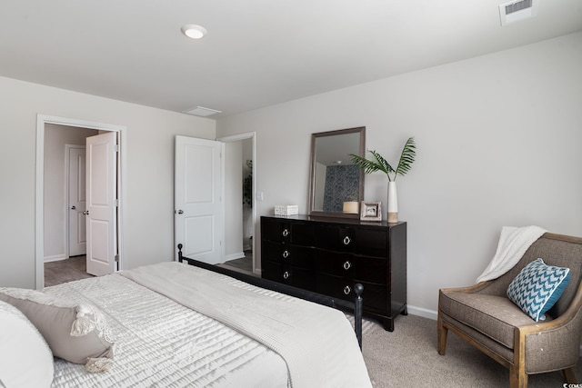 bedroom with carpet, visible vents, and baseboards