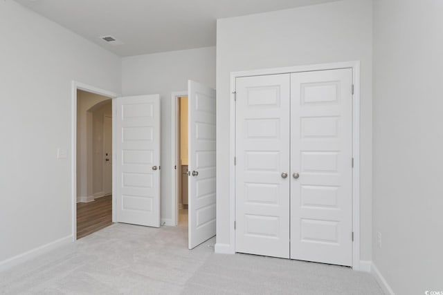 4036 Bucolic Loop, Myrtle Beach, SC 29588 - unfurnished bedroom with arched walkways, light carpet, and a closet