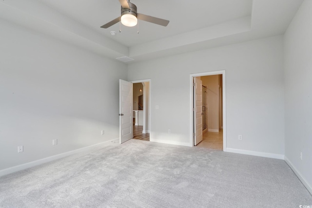 4036 Bucolic Loop, Myrtle Beach, SC 29588 - unfurnished bedroom featuring light colored carpet, ensuite bathroom, ceiling fan, and a raised ceiling