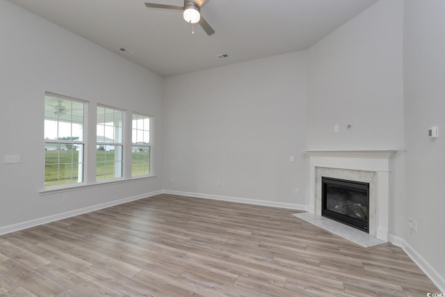 4036 Bucolic Loop, Myrtle Beach, SC 29588 - unfurnished living room with ceiling fan, light wood-style floors, and a high end fireplace