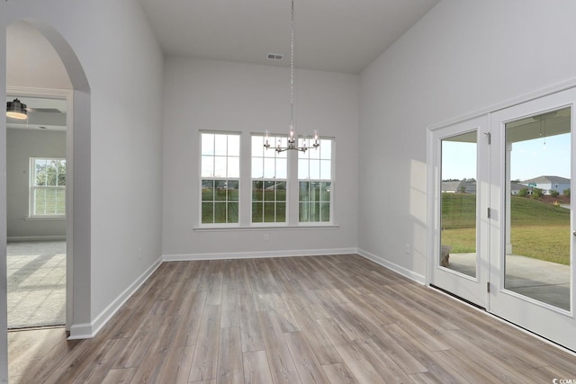 4036 Bucolic Loop, Myrtle Beach, SC 29588 - unfurnished dining area with wood finished floors, arched walkways, and a chandelier