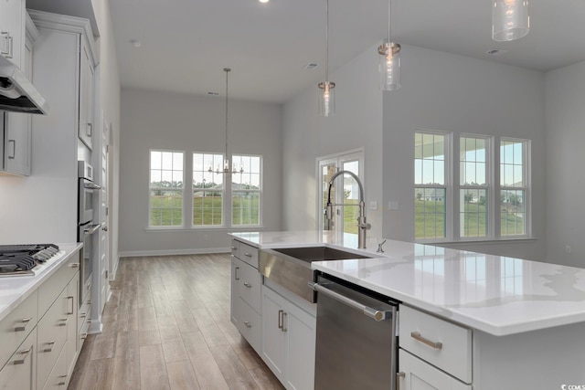 4036 Bucolic Loop, Myrtle Beach, SC 29588 - kitchen featuring appliances with stainless steel finishes, a center island with sink, plenty of natural light, light wood-style floors, and a towering ceiling