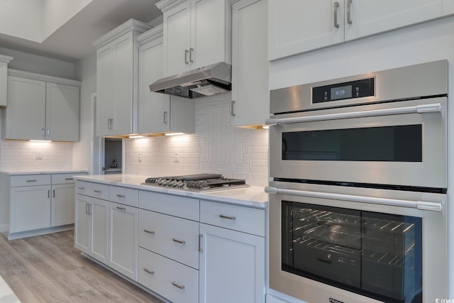 4036 Bucolic Loop, Myrtle Beach, SC 29588 - kitchen with stainless steel appliances, light countertops, light wood finished floors, backsplash, and under cabinet range hood
