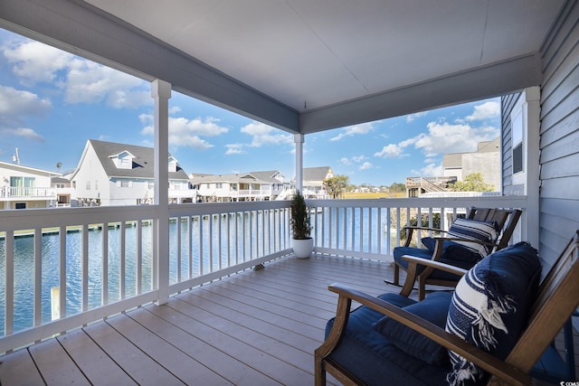 wooden deck with a water view and a residential view