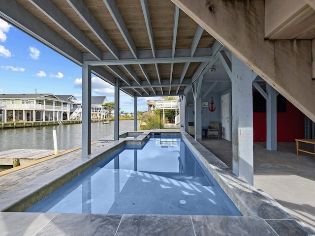 pool with a patio, a water view, and a residential view