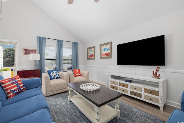 living room with lofted ceiling, wainscoting, and a wealth of natural light