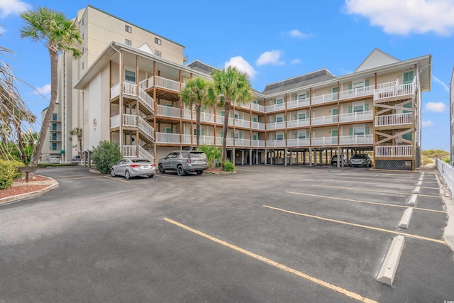 view of building exterior with uncovered parking