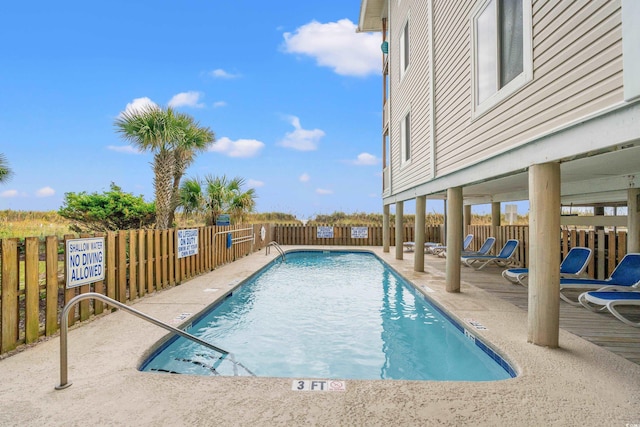 pool with a patio area and a fenced backyard