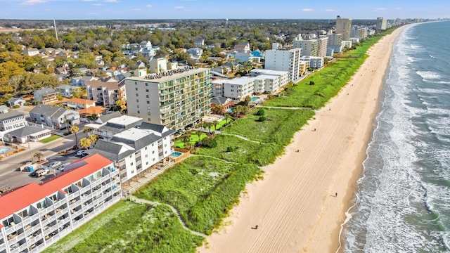 birds eye view of property featuring a city view, a water view, and a beach view