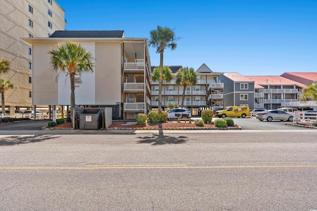 view of building exterior with uncovered parking