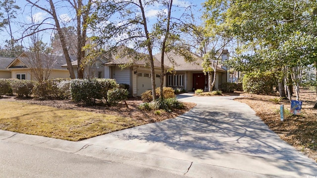 ranch-style house with a garage and concrete driveway