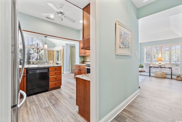 kitchen with light wood finished floors, black dishwasher, visible vents, brown cabinets, and freestanding refrigerator