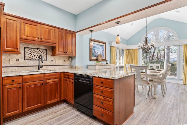 kitchen featuring a peninsula, a sink, light stone countertops, dishwasher, and brown cabinetry