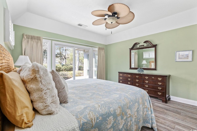 bedroom with visible vents, ceiling fan, wood finished floors, access to outside, and baseboards