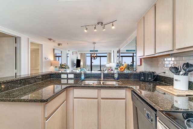 kitchen featuring dishwasher, backsplash, a sink, and light brown cabinets