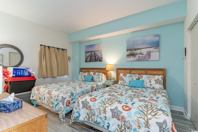 bedroom with wood tiled floor and baseboards