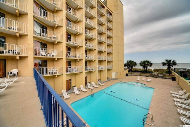 pool featuring a patio area and fence