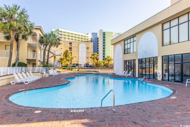 pool featuring a patio area and fence