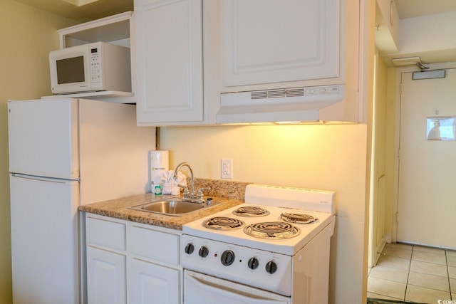 kitchen with white appliances, white cabinets, under cabinet range hood, a sink, and light tile patterned flooring