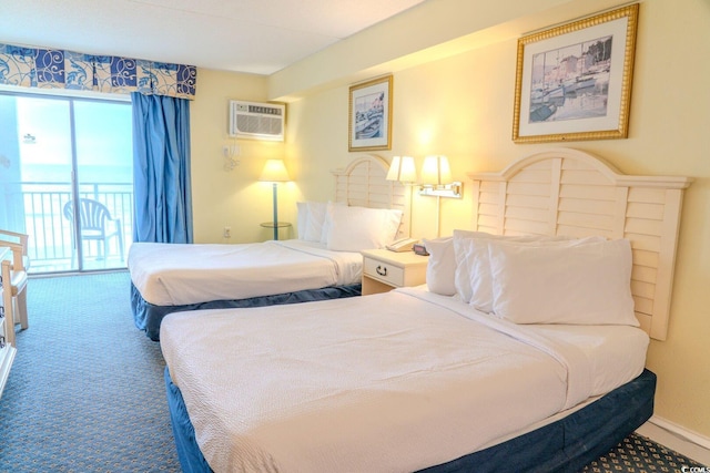 carpeted bedroom with baseboards, an AC wall unit, and access to exterior