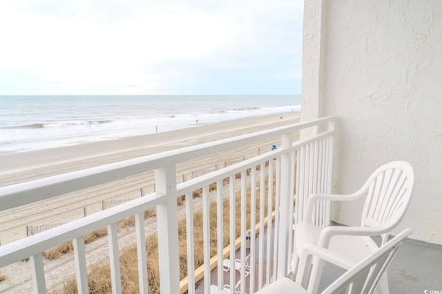 balcony with a beach view and a water view