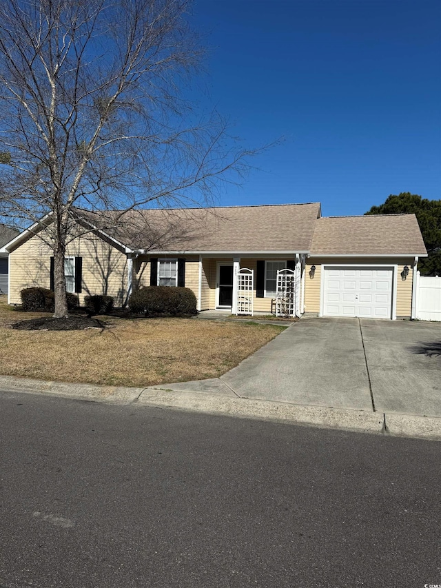 ranch-style house featuring a shingled roof, a porch, an attached garage, fence, and driveway