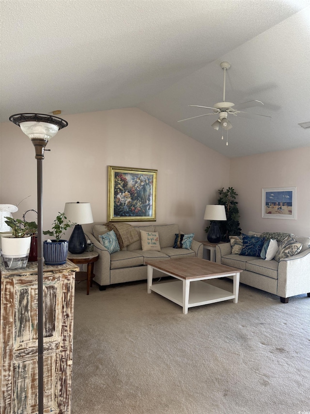 carpeted living area with a ceiling fan, lofted ceiling, and a textured ceiling