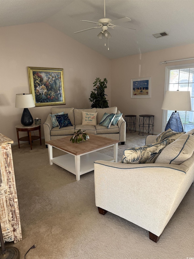 living room featuring carpet floors, lofted ceiling, visible vents, and a ceiling fan