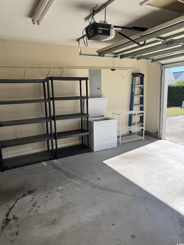 garage with electric panel and a garage door opener