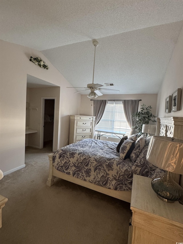 bedroom featuring visible vents, light carpet, vaulted ceiling, a textured ceiling, and ceiling fan