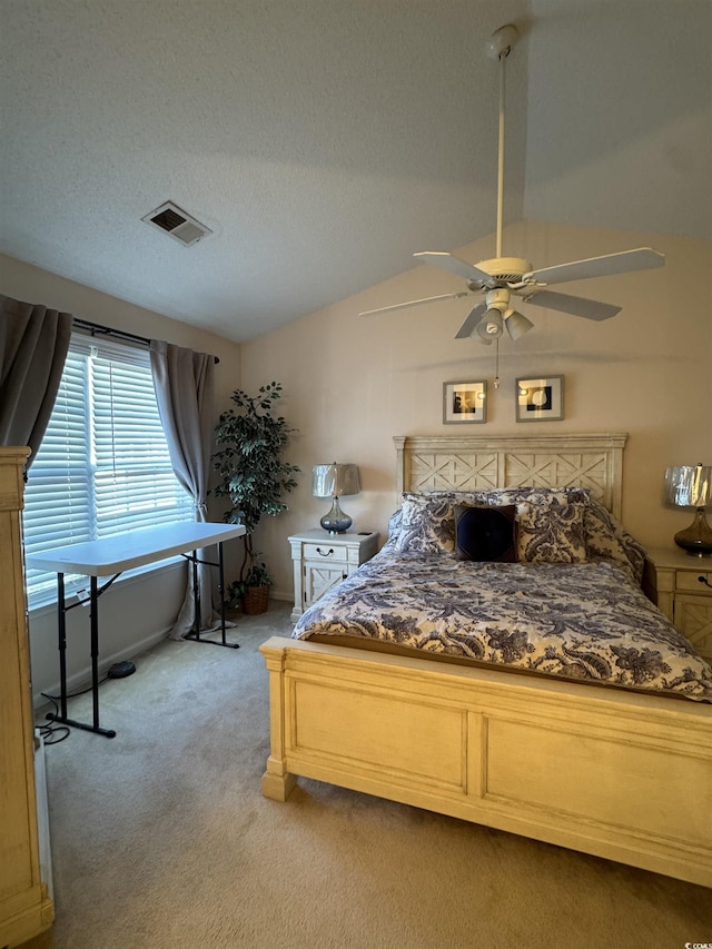 bedroom with light carpet, visible vents, ceiling fan, vaulted ceiling, and a textured ceiling