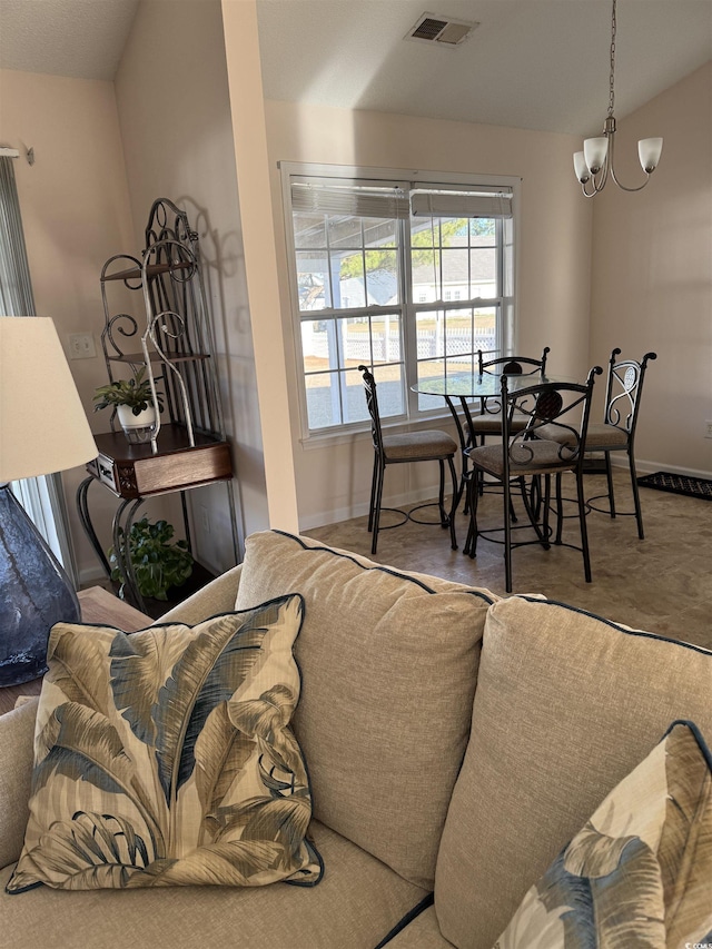 living room featuring vaulted ceiling, baseboards, visible vents, and an inviting chandelier