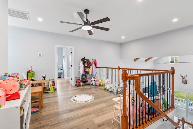 game room with a wealth of natural light, light wood-type flooring, visible vents, and recessed lighting