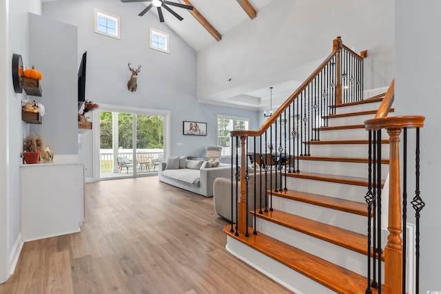 interior space with high vaulted ceiling, beamed ceiling, wood finished floors, and a ceiling fan