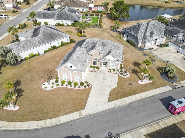 birds eye view of property featuring a residential view and a water view