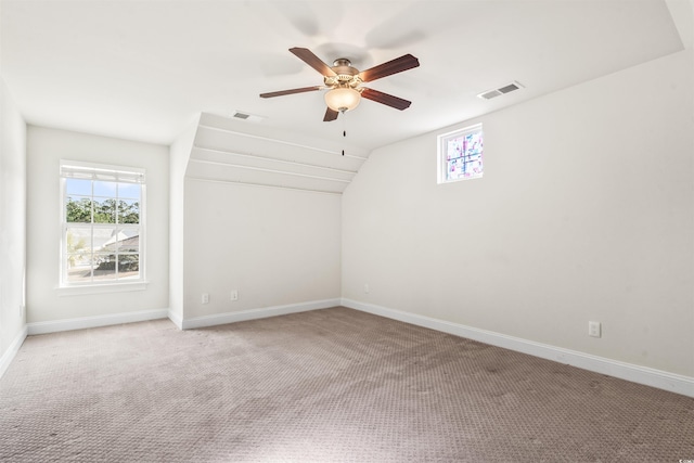 spare room featuring baseboards, visible vents, and light colored carpet