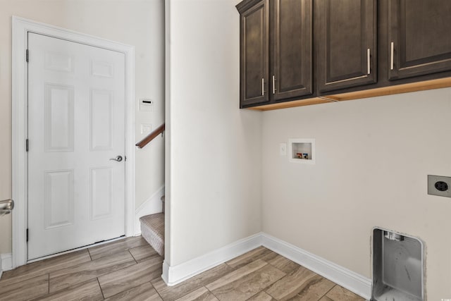 laundry area featuring washer hookup, wood finish floors, cabinet space, electric dryer hookup, and baseboards